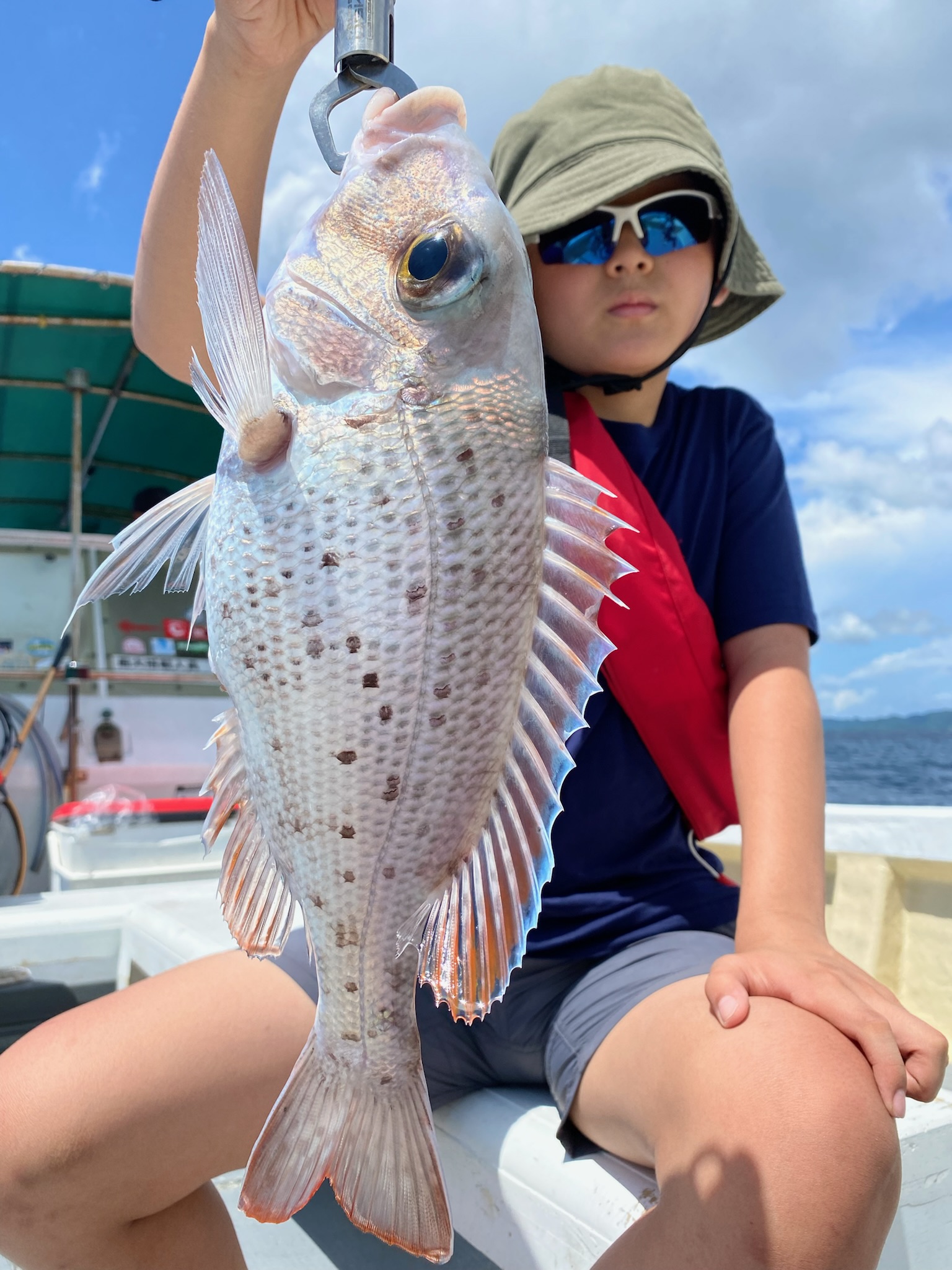 大きな魚を釣った子供