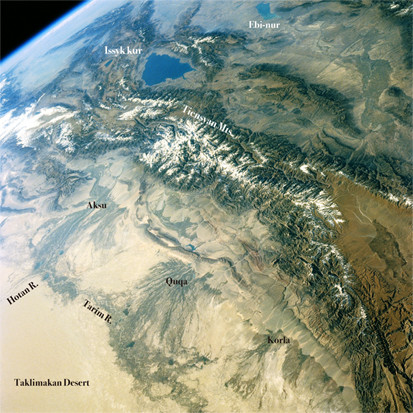 Spectacular scene of Tienshan mountains lies to the north and west of the Taklamakan Desert view from space. ©NASA/GSFC.