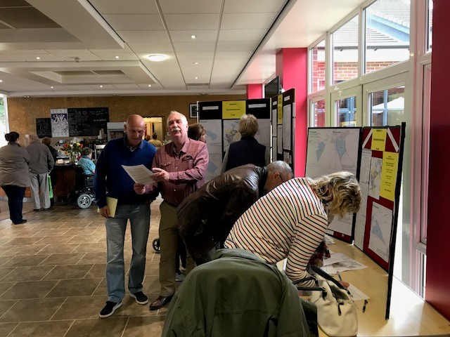 Local residents viewing the display and completing surveys at the roadshow