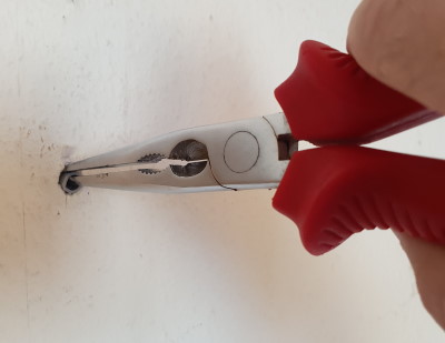 Remove the plug with a pair of needle-nose pliers