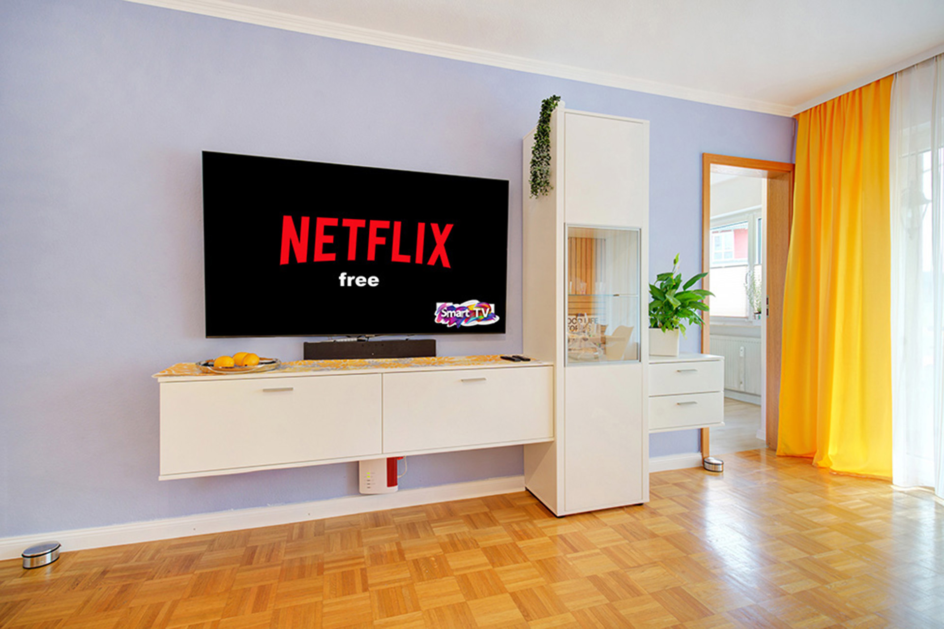 Bild eines modernen Fernsehbereichs in einer Ferienwohnung; auf dem Monitor ist das Netflix-Logo zu sehen