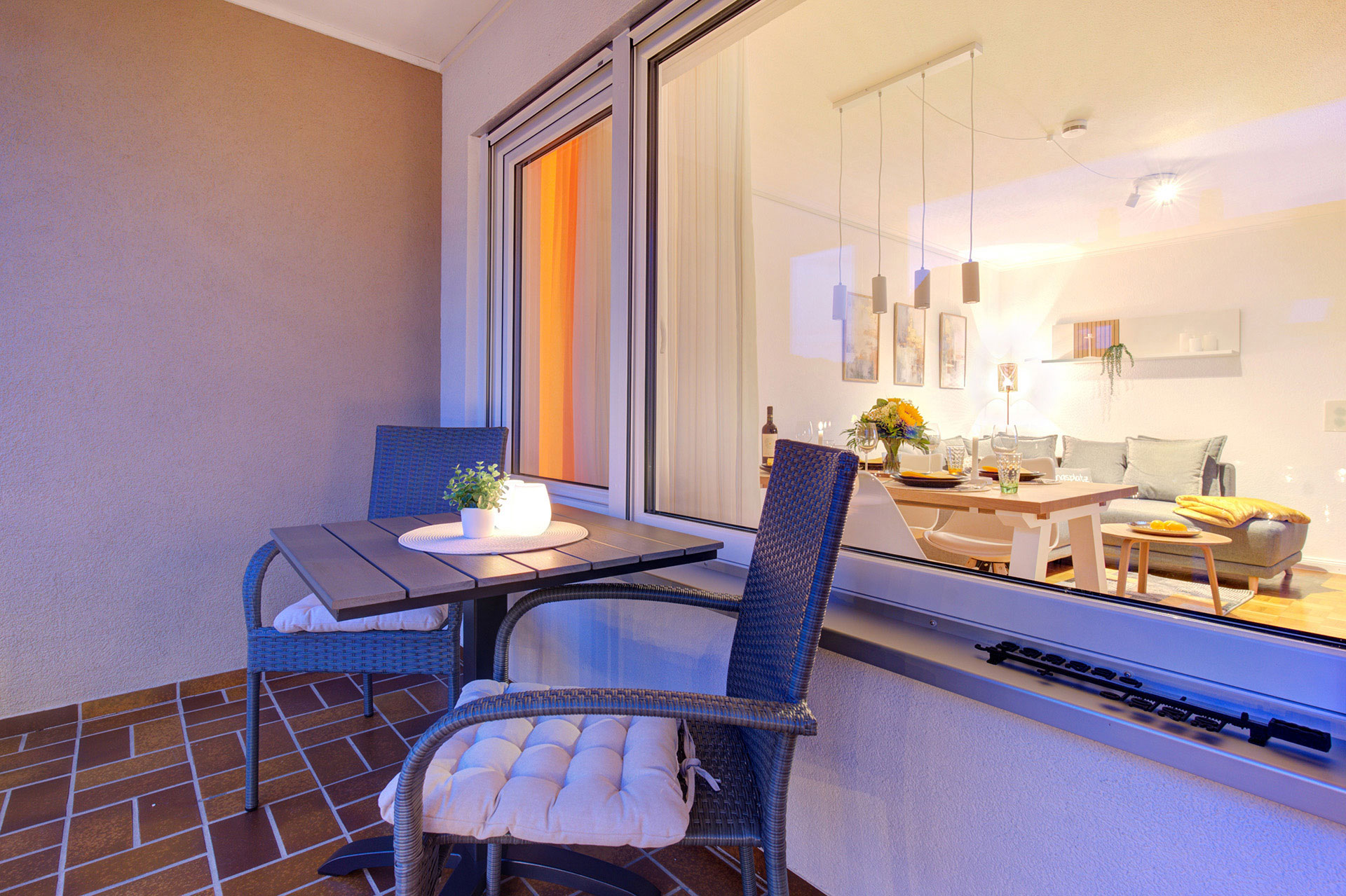 ferienwohnung fotografieren - balkon der Ferienwohnung bei blauem Licht in Abendstimmung und blick in das Wohnzimmer