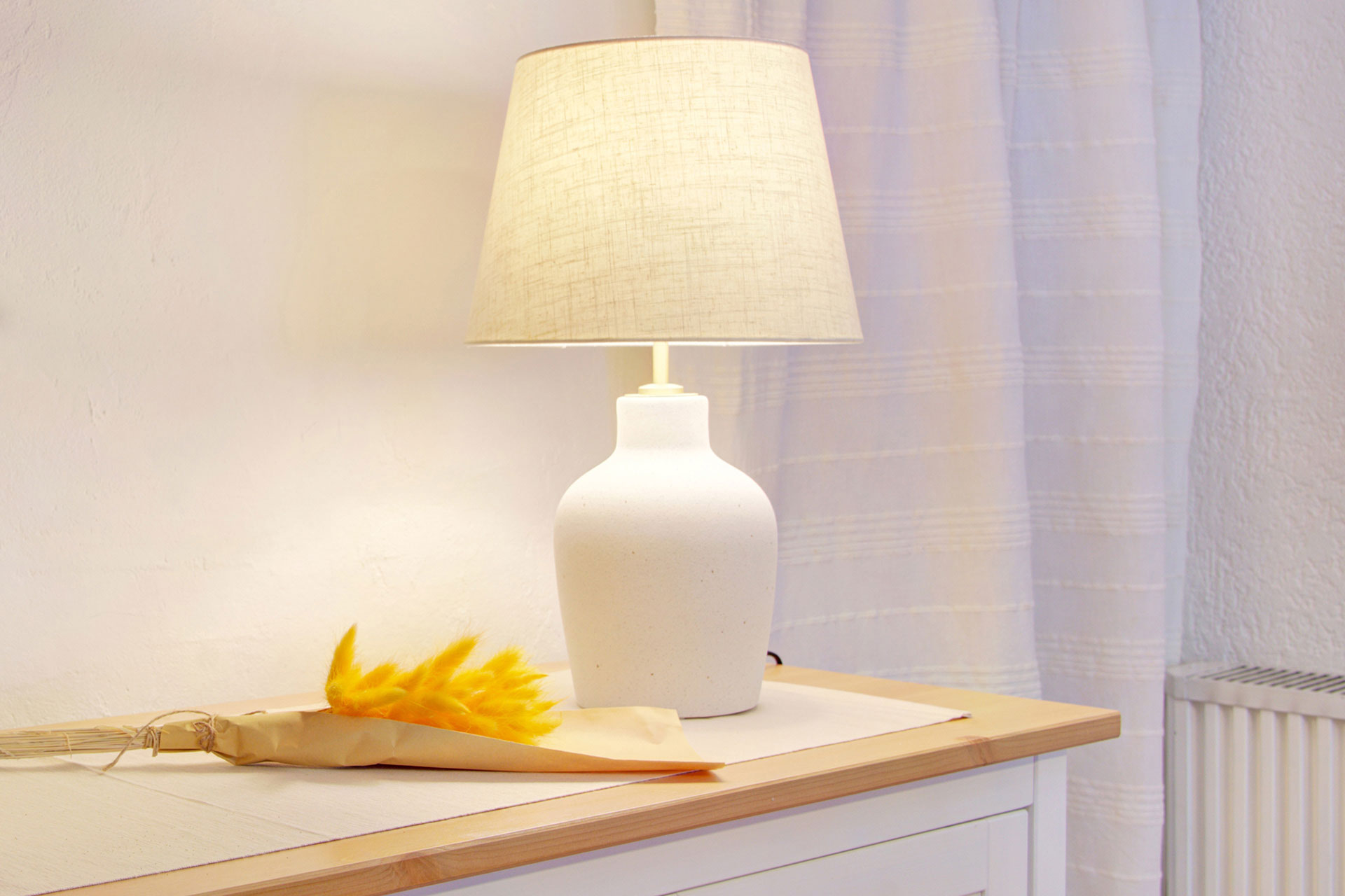 stimmungsvolle lampe mit trockenblumen in ferienhaus