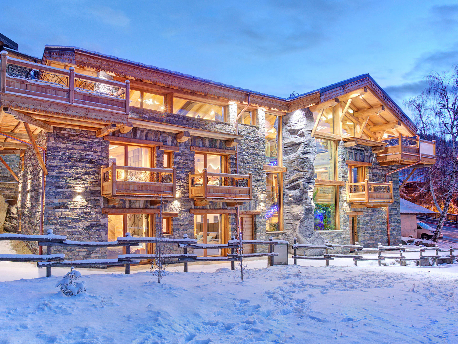 Beleuchtetes Rückseite des Chalets nachts mit Schnee