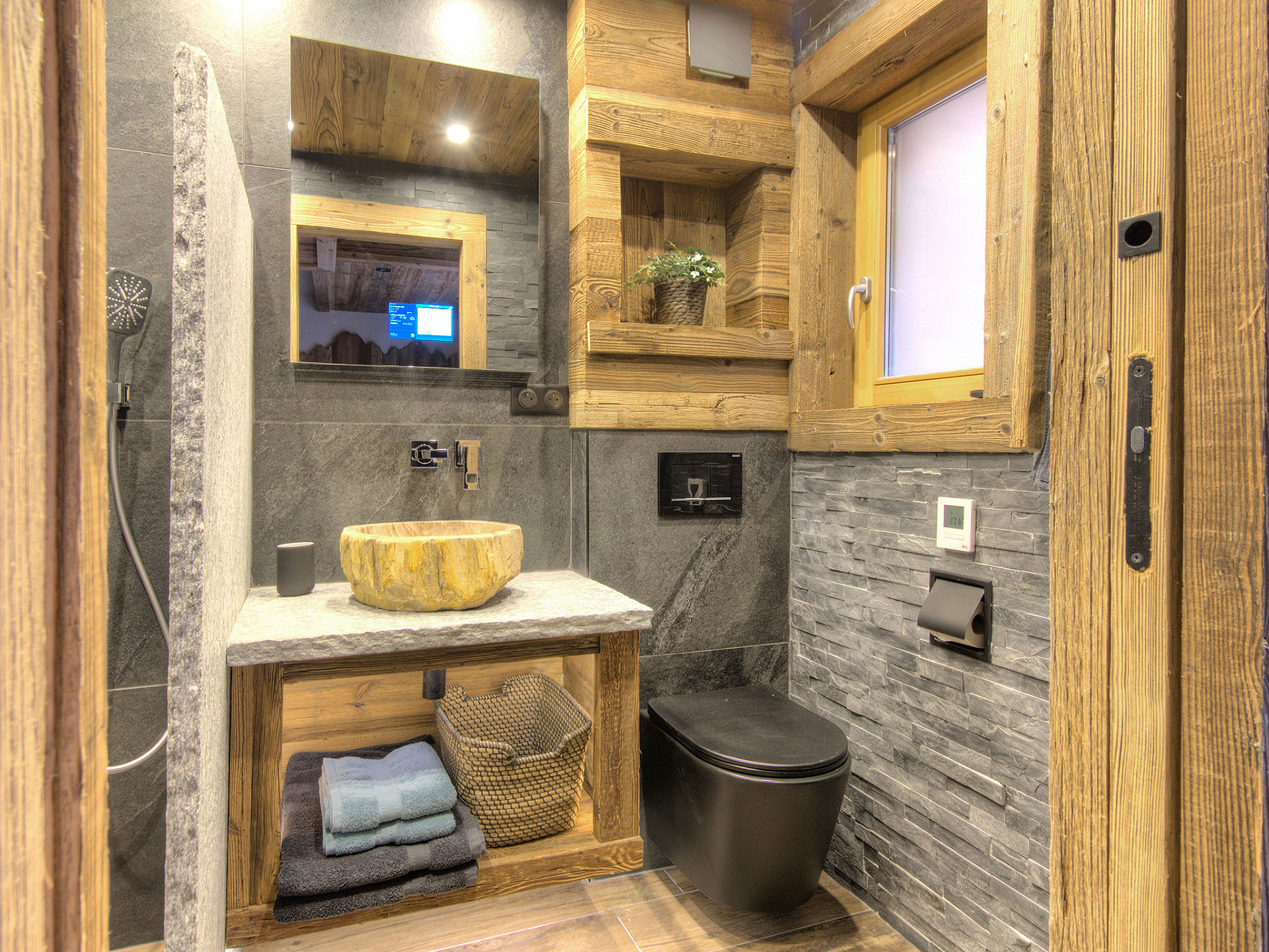 Hochwertiges Immobilienfoto -Badezimmer aus Holz und Stein mit Internetspiegel