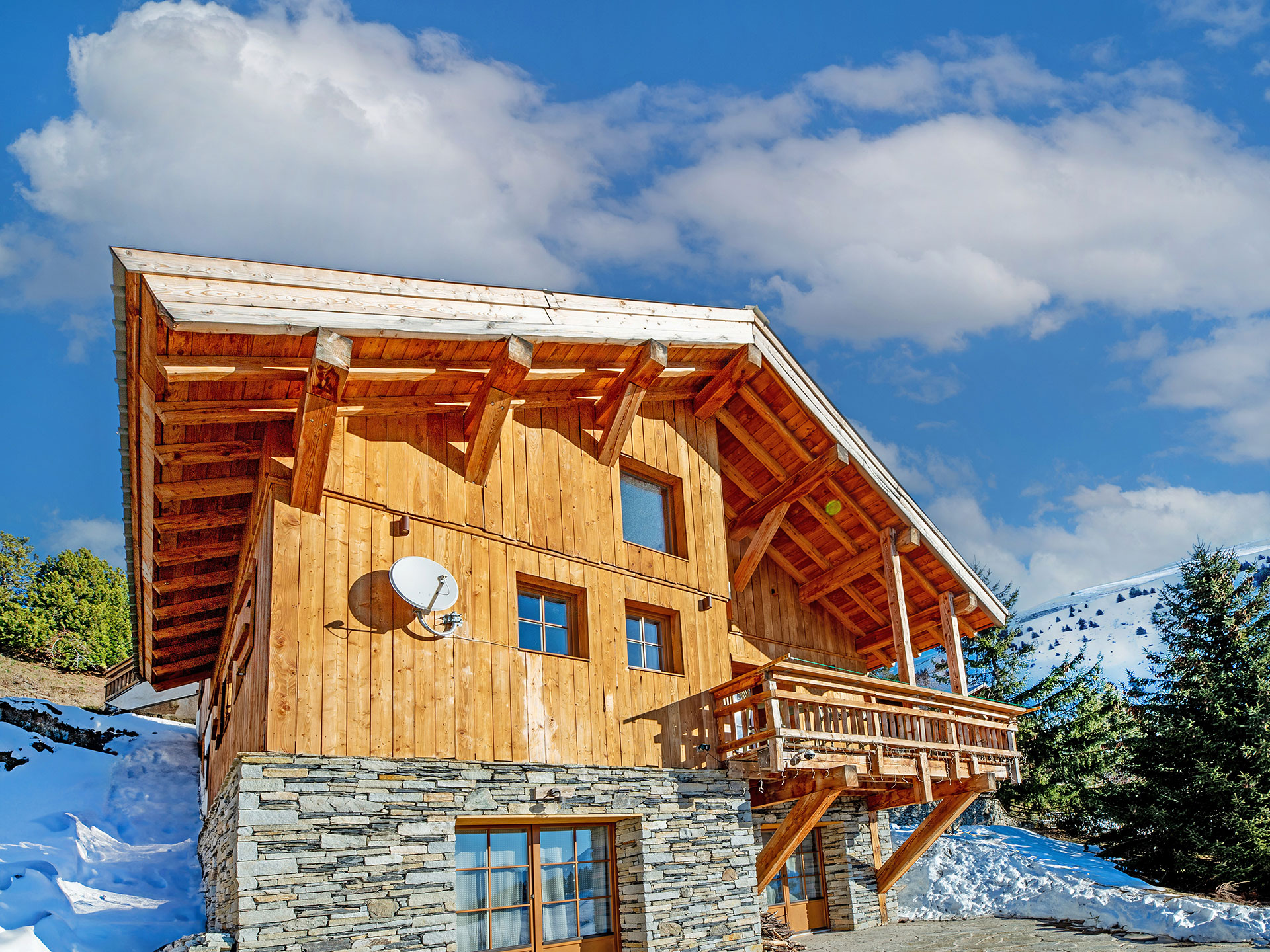 Traditionelles Chalet-Setting im Frühling, Schnee, kühler Blauhimmel, holzbetonte Architektur - nachher