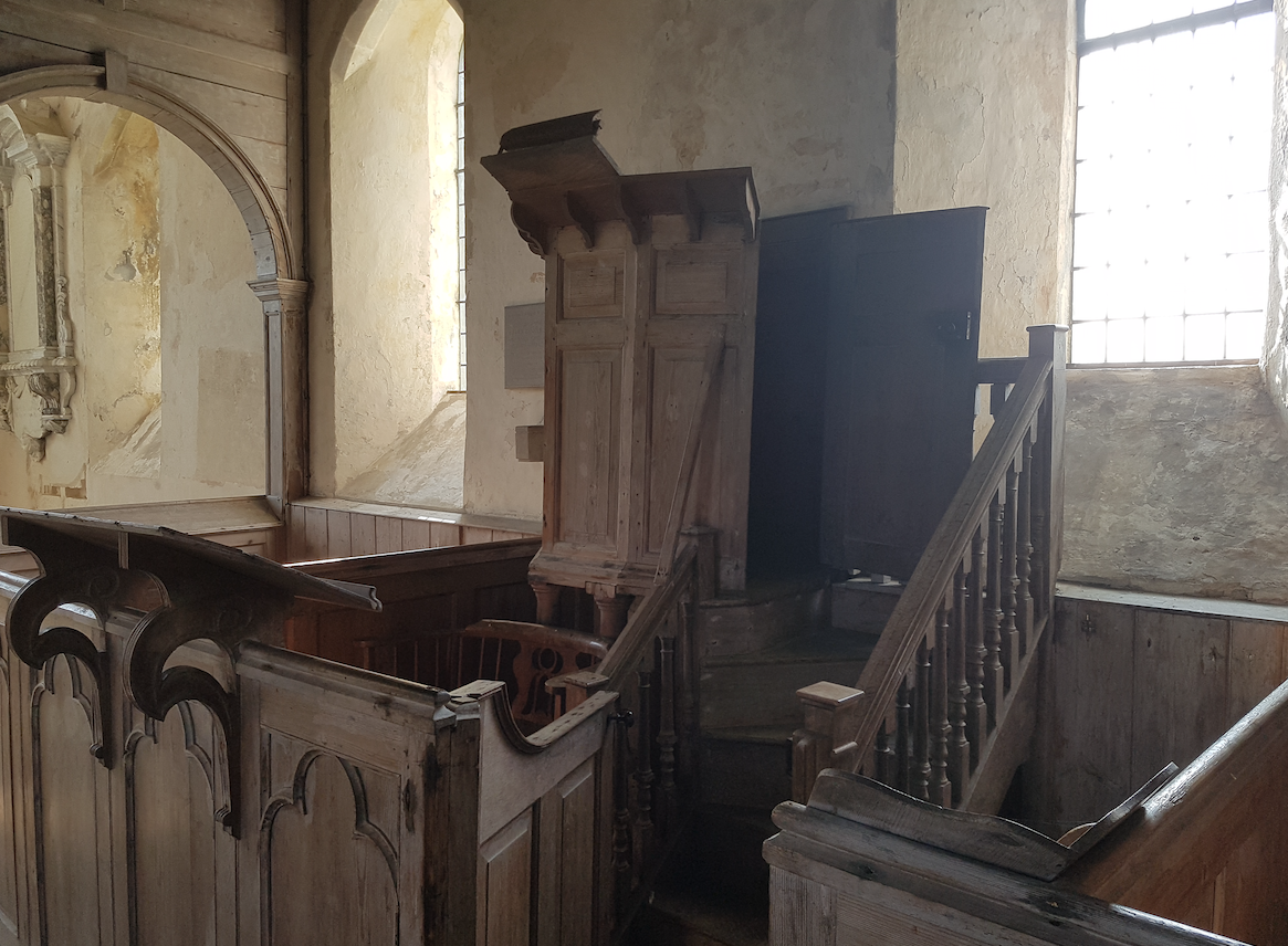 beneath the pulpit, the clerk's elmwood chair was tailor-made for a vast posterior. On the right is a lectern designed for a corner position