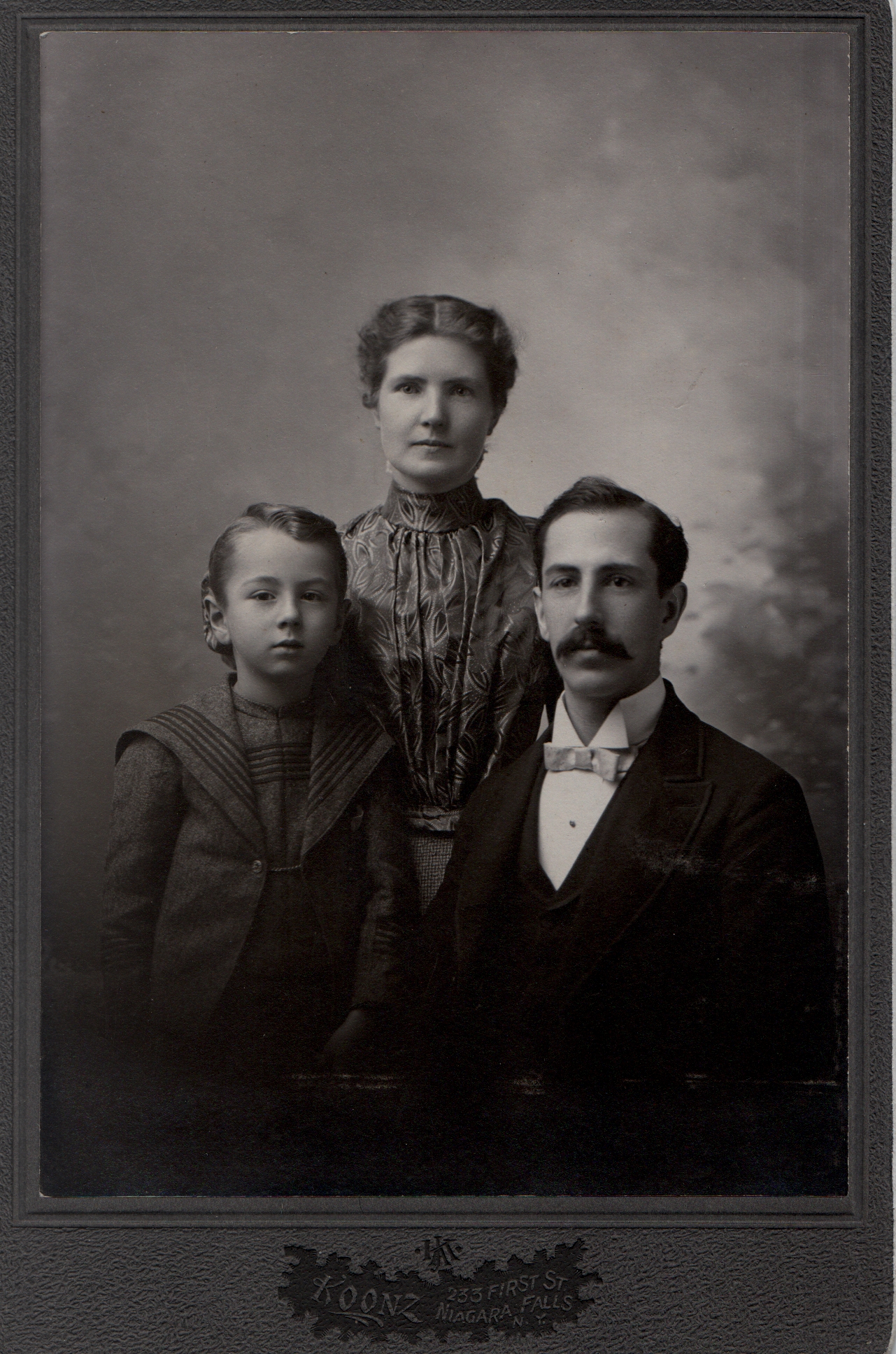 Alberta Hodson, her husband Herbert Frederick Polhill and son. circa 1898. Reverse ' to aunt with love.'