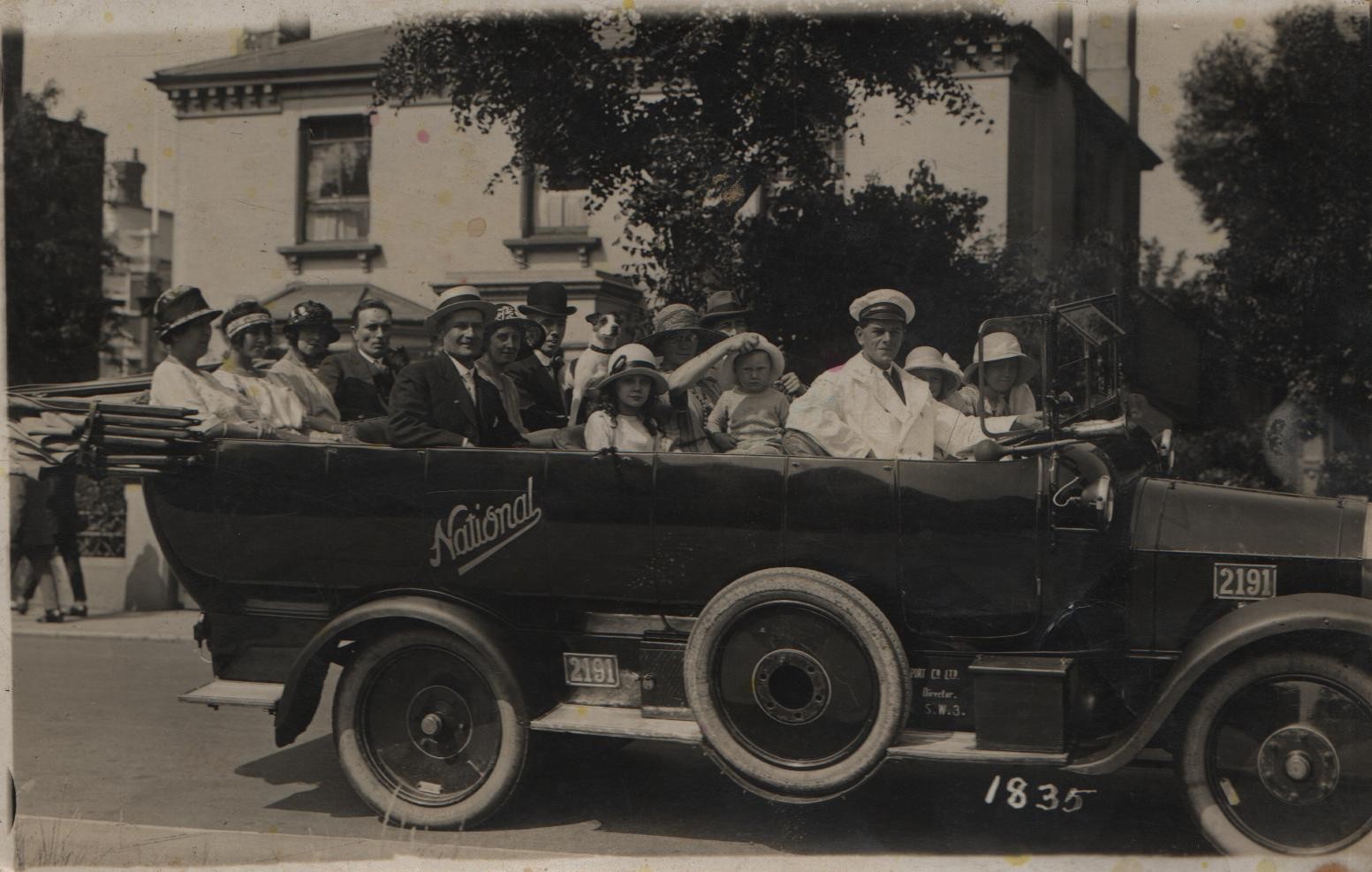 circa 1923-4 Clacton-on-Sea Joan and Dorothy are next to the driver. David is on his other's lap having hat brim pulled up by K.M.Lilley. Hat and forehead of J G Lilley behind.