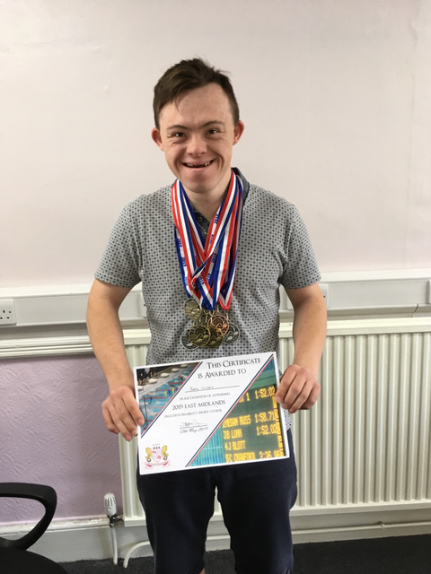 Jake with his medals and certificate