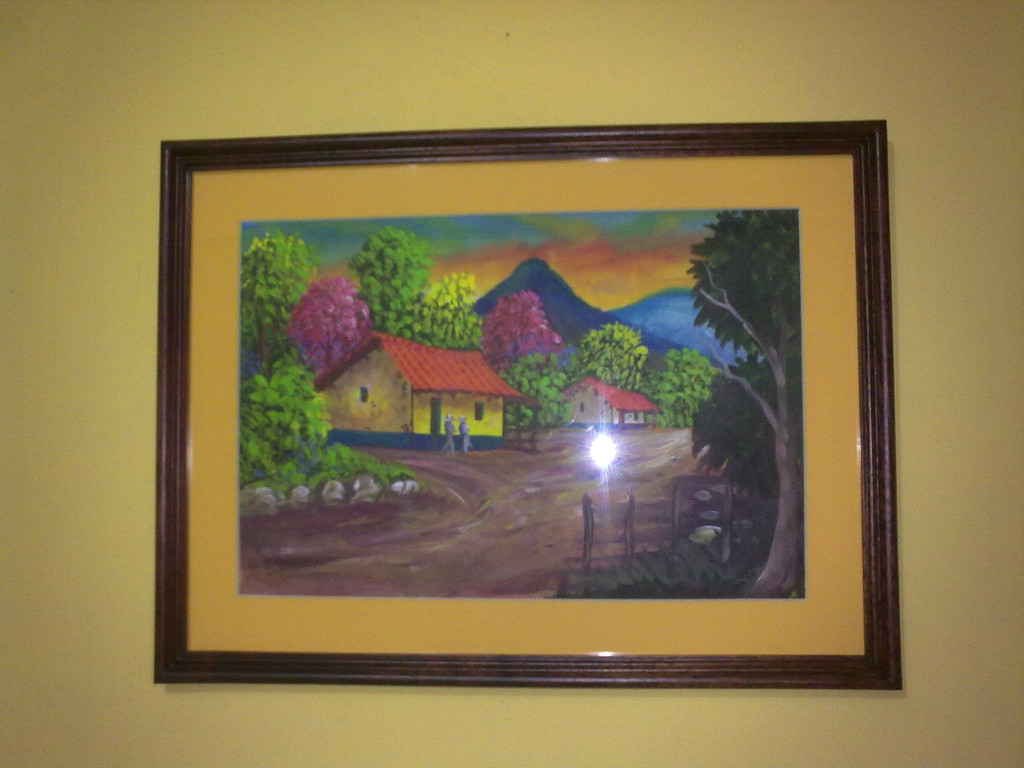 Enmarcado de paisaje típico costarricense, técnica pintura de agua, en moldura m 22, tinte caoba, maría luisa cartón de presentacion amarillo, cartón gris de respaldo y vidrio.