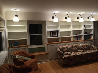 wall-to-wall shelves, cabinets, window seat and lights