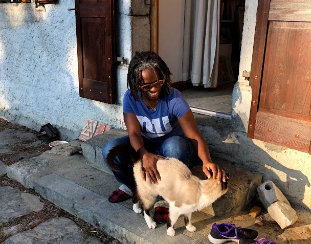 Tara petting a cat.