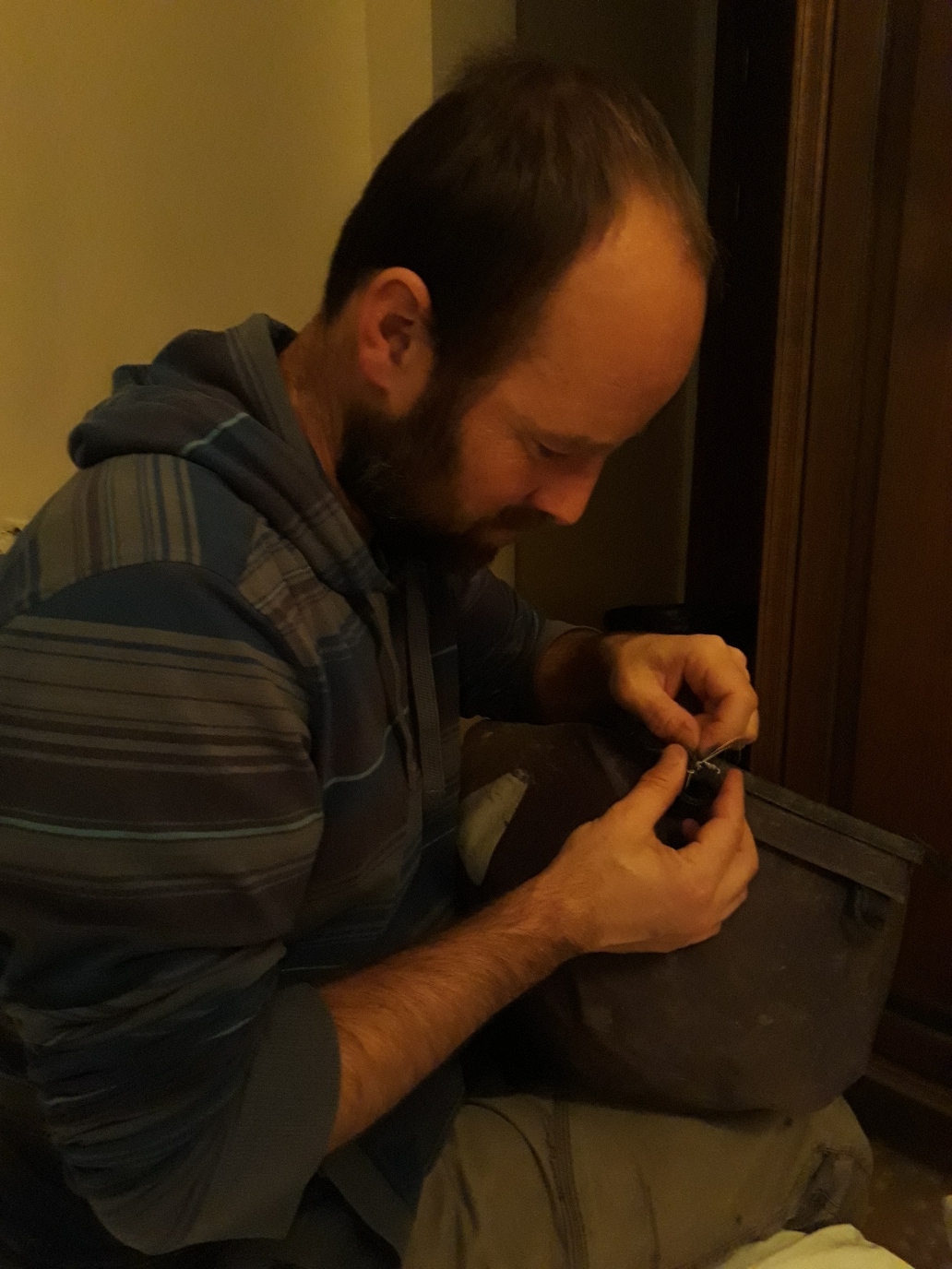 Percy is sewing his broken saddlebag