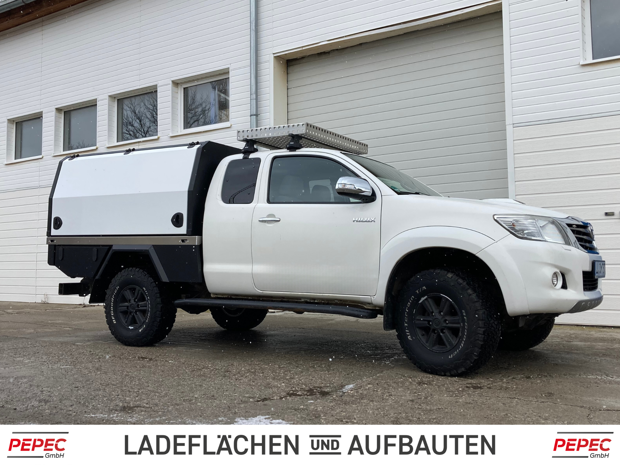 Toyota Hilux Extra Cab Pickup mit umgebautem Flatbed Festaufbau und lackierten Seitenklappen