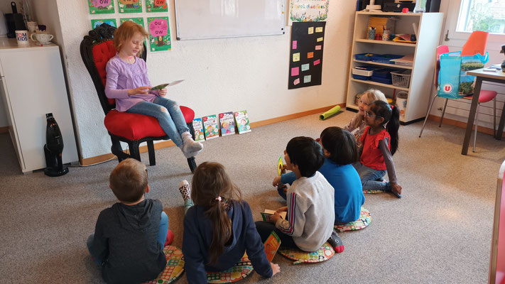 Children practice reading to the class