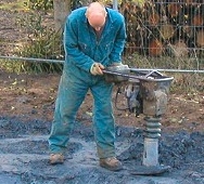 Using a wacker plate to puddle the clay