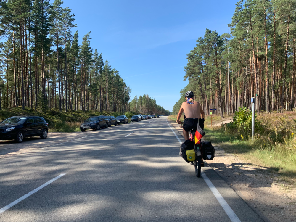 Der Straßenrand ist voll von Autos, deren Besitzer am Strand sind