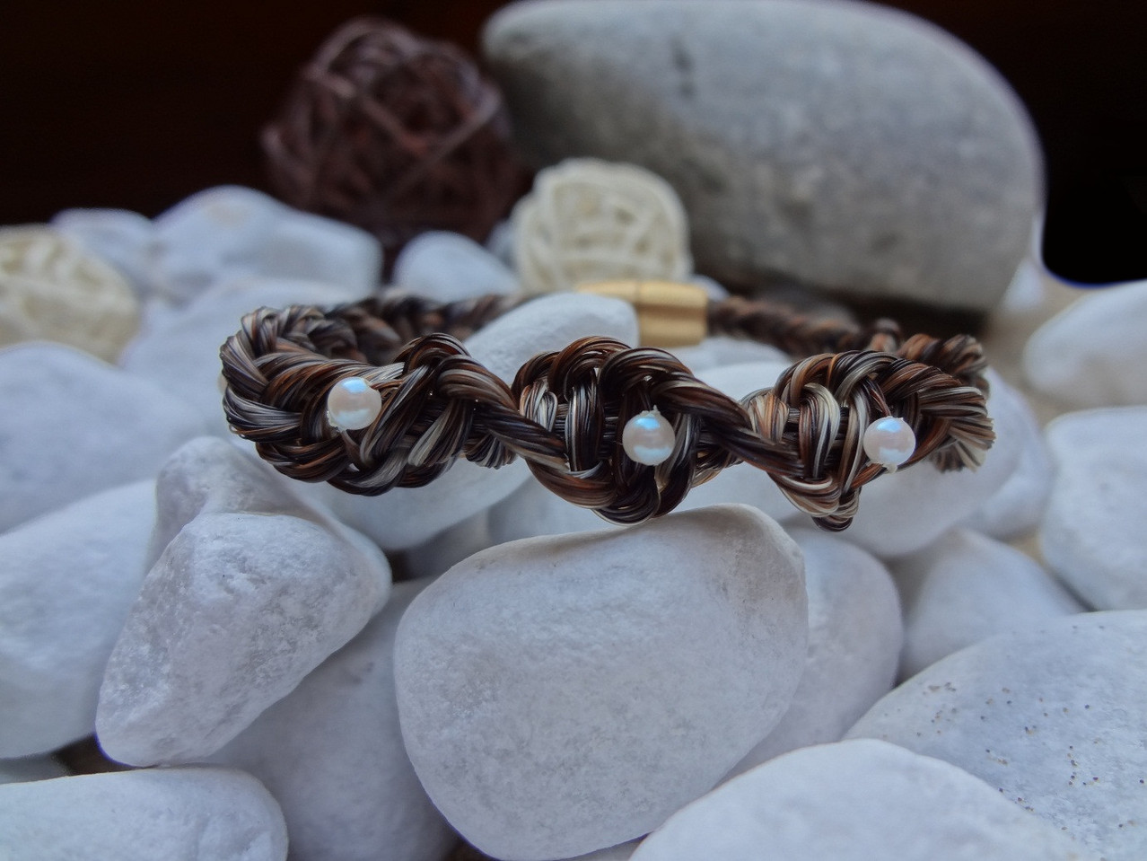 Gedrehtes Armband mit crémefarbenen Kunstperlen und goldfarbenem Magnetverschluss