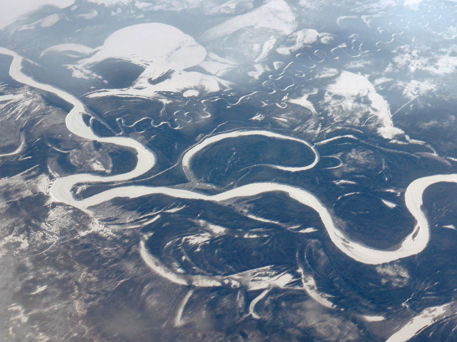 Frozen rivers meandering through forest
