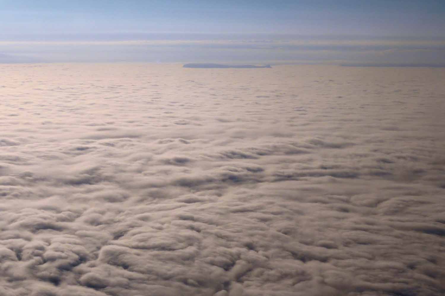 Icelandic mountains poking through the cloud layer
