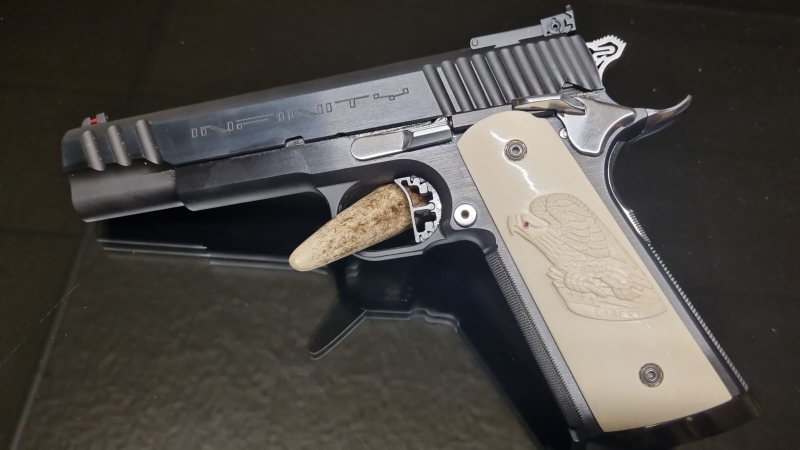 Infinity 1911 with carved ivory grips.