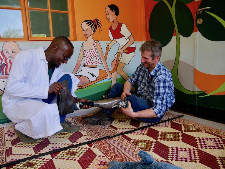 Chatting with one of the prosthetists at CoRSU Hospital in Uganda.