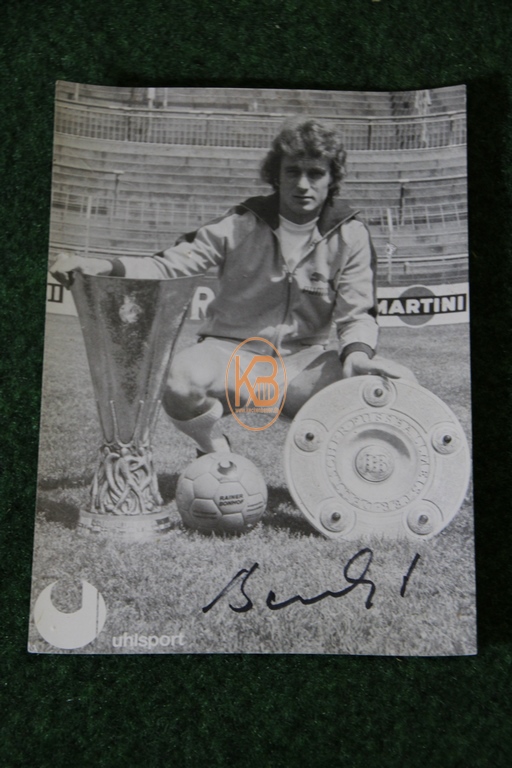 Original Autogrammkarte von Rainer Bonhof im Trikot von Borussia Mönchengladbach mit der Meisterschale und dem UEFA Pokal aus dem Jahr 1975