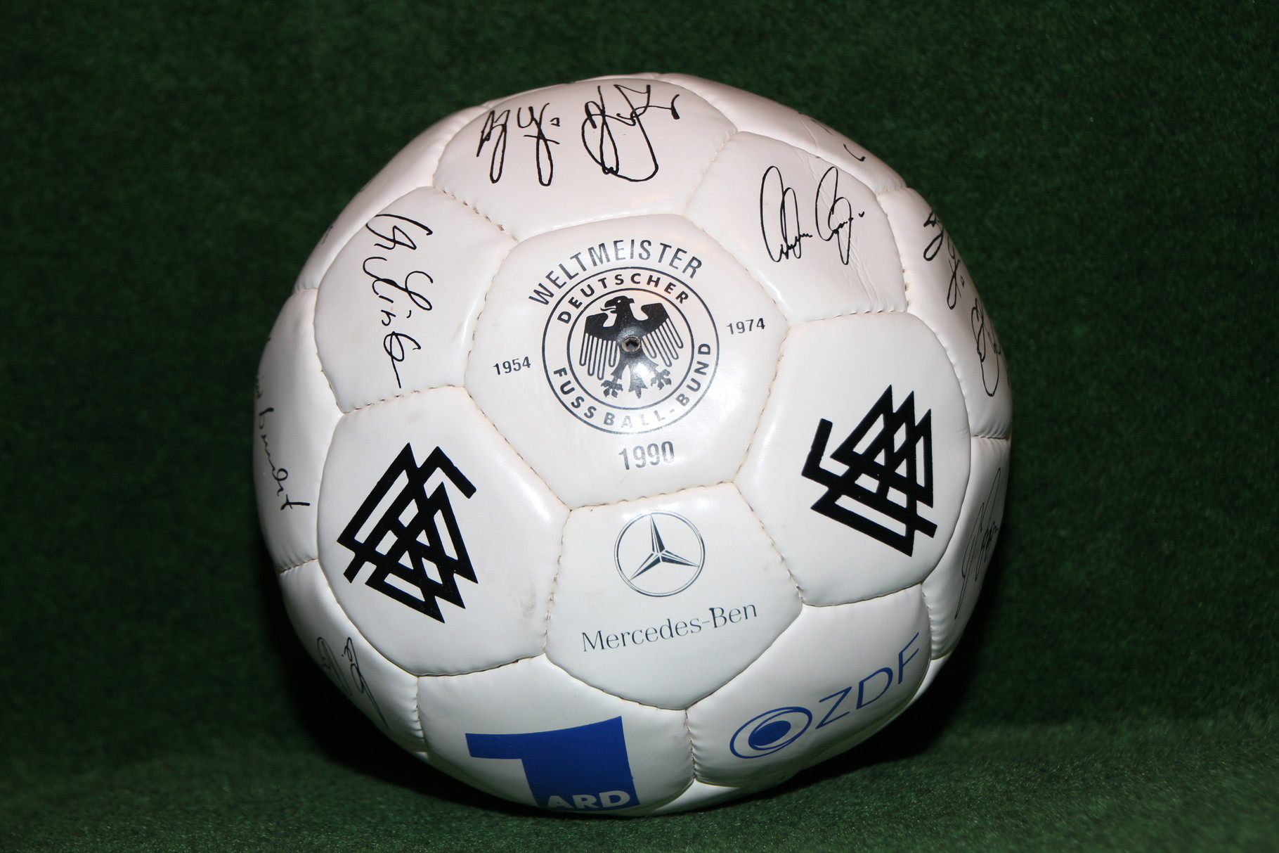 Ball mit aufgedruckten Unterschriften des Weltmeisterkaders der WM 1990 in Italien.