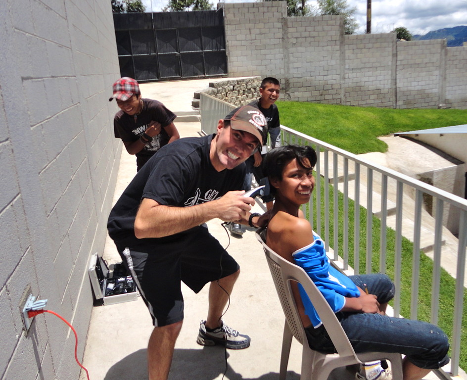 brock cutting jancer's hair at the boys academy