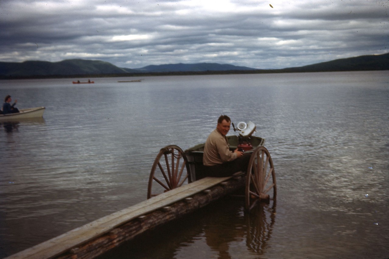 On dock, unknown man at Harding Lake in 1940's.  Looks like he had a good method to get the dock in and out of the lake.