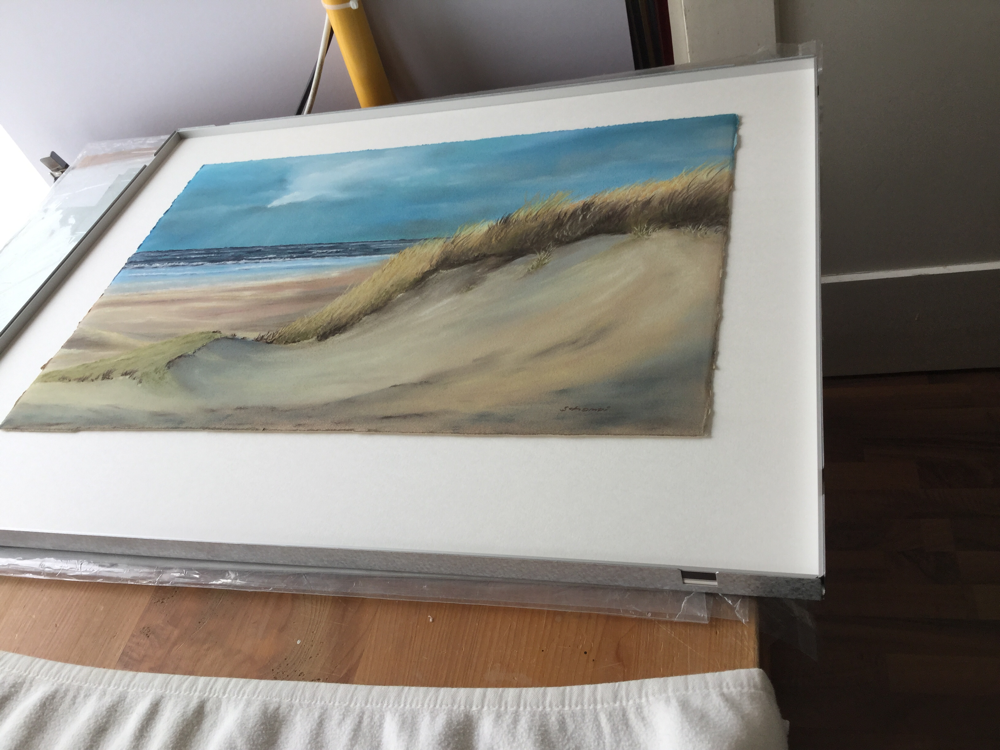 The pastel picture is inserted into the box frame so that it appears to float 