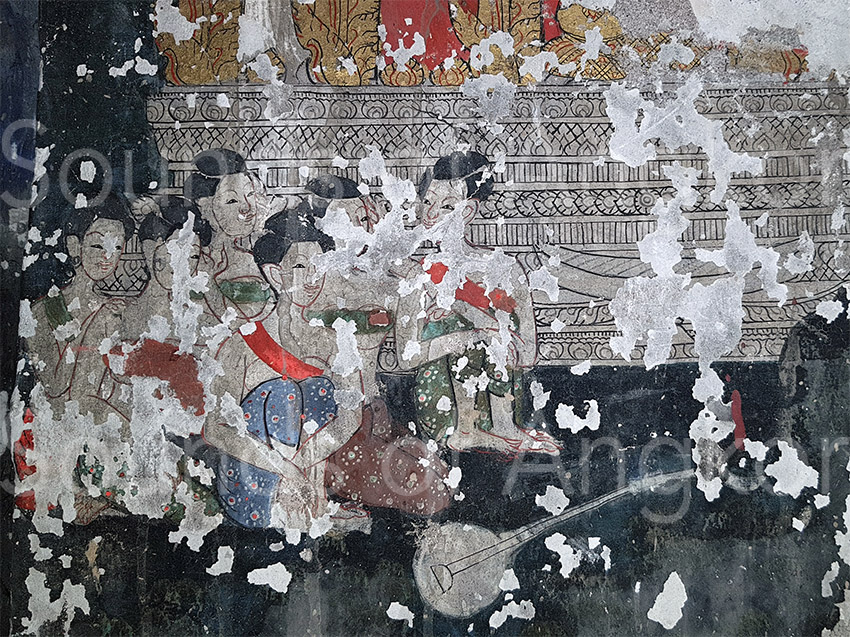 Female musicians in the scene of "The Great Departure" of Prince Siddhartha. On the floor a two-stringed lute and behind a xylophone.