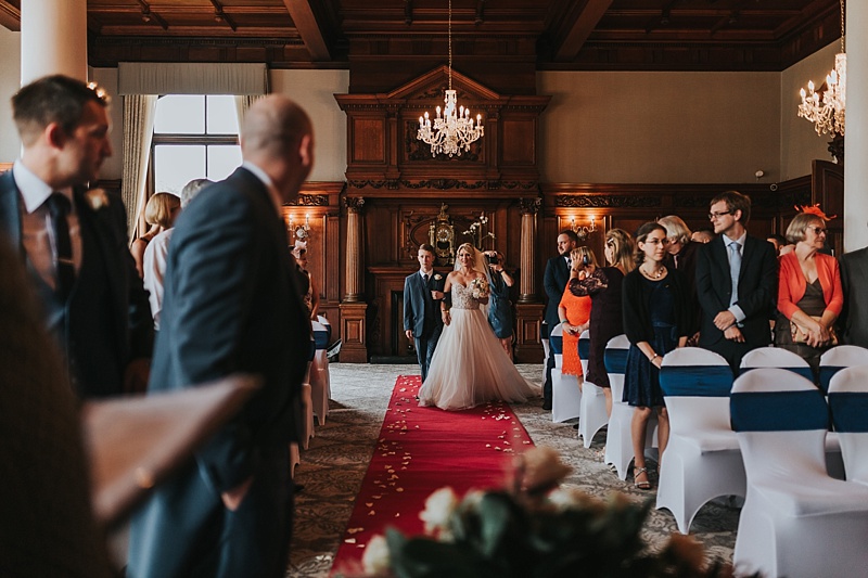 bride being walked down the aisle by her son