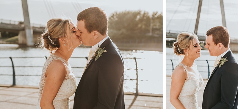 Sunset wedding portraits showing bride and groom kissing on the marine lake