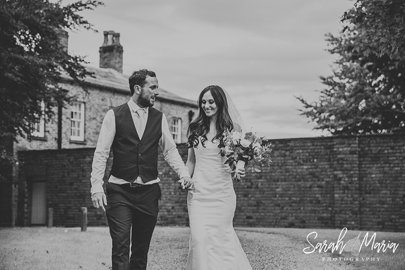 bride and groom portrait in front of meols hall wedding venue