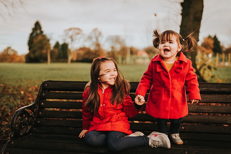 sisters having fun at the park during autumn in lancashire