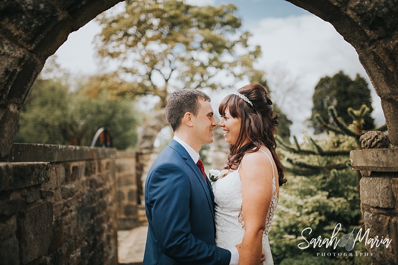 portrait of a bride and groom under the arch at Ferraris country house hotel