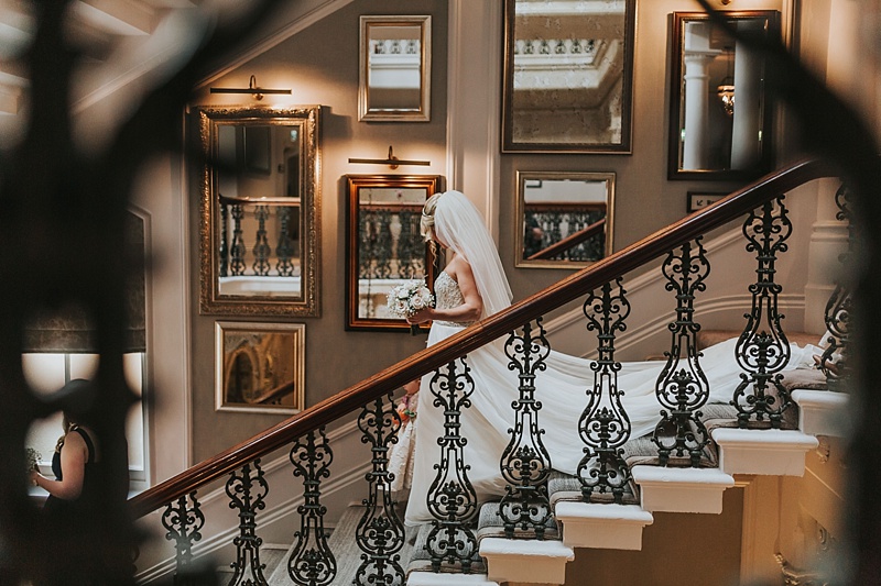 bride walking down the stairs on the way to her wedding ceremony at the principal York hotel