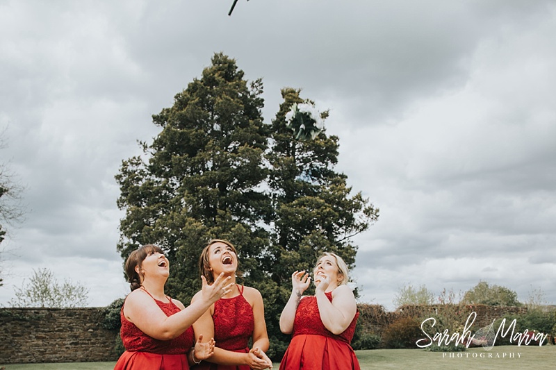 funny photo of bridesmaids throwing their bouquets up in the air