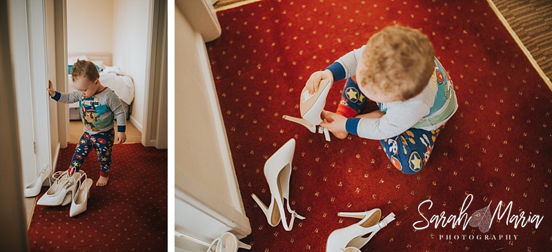 a little boy trying to put on a pair of high heeled shoes