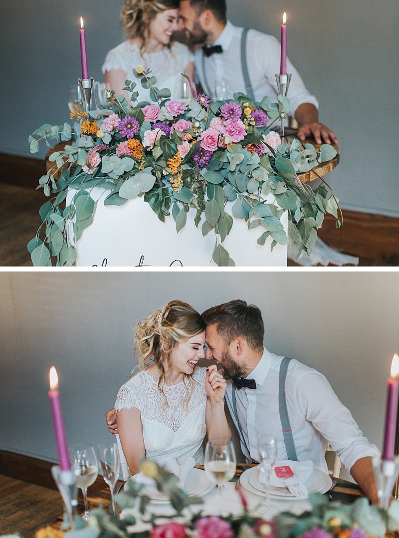 a bride and groom sat at a sweetheart table