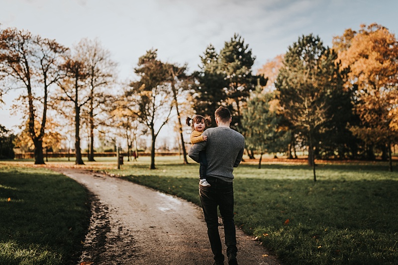 dad and daughter walking away during family portraits