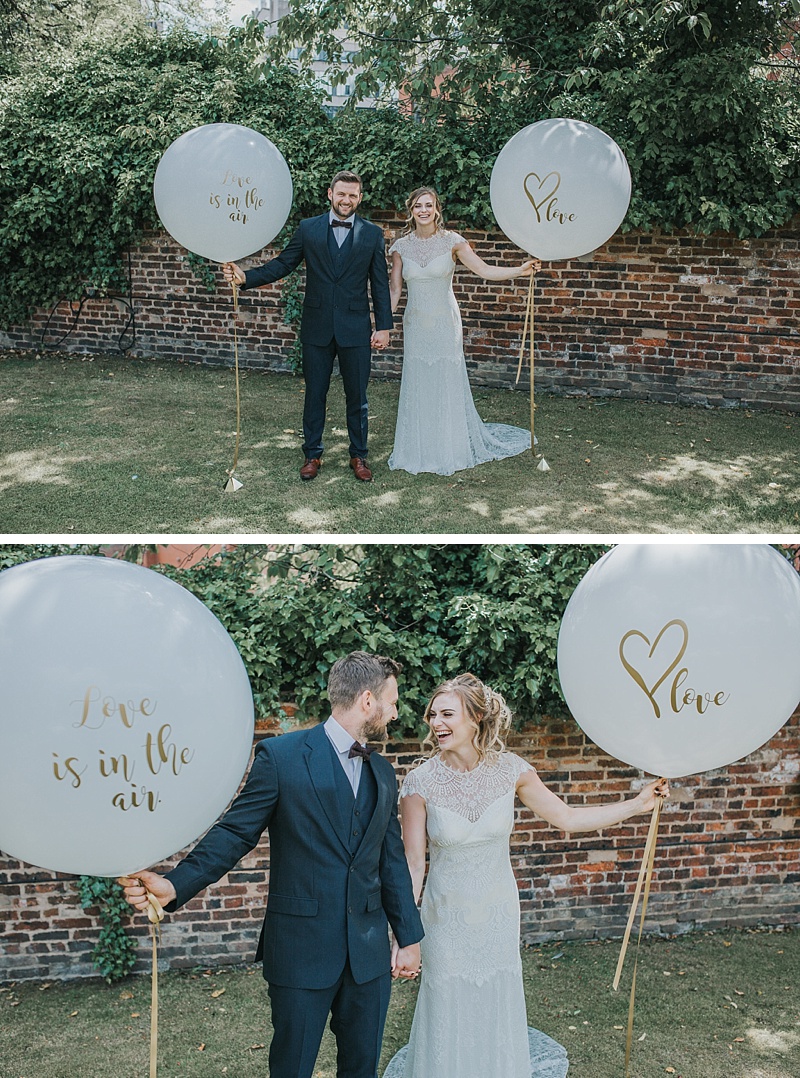 bride and groom with giant wedding balloons