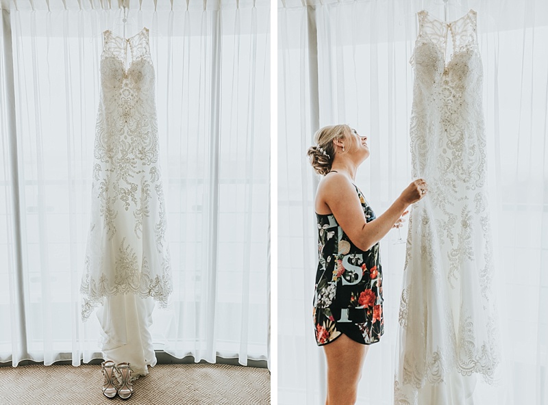 bride looking at her Mori Lee wedding dress on her wedding day