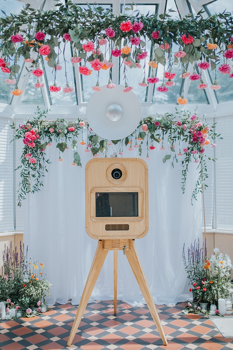 viva la booth photobooth infront of a wedding arbour