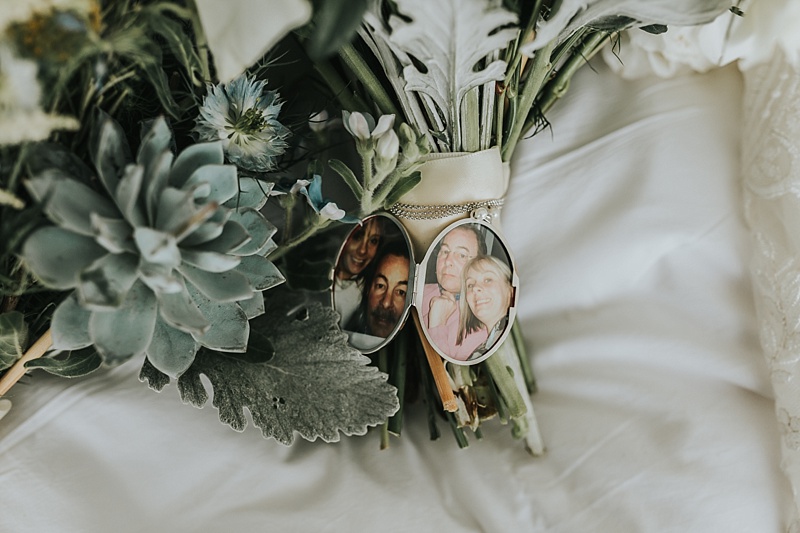 Wedding bouquet with memorial locket showing photographs of bride and her late father