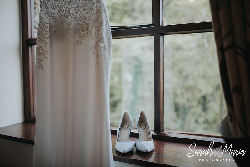 a detail shot of a wedding dress and bridal shoes