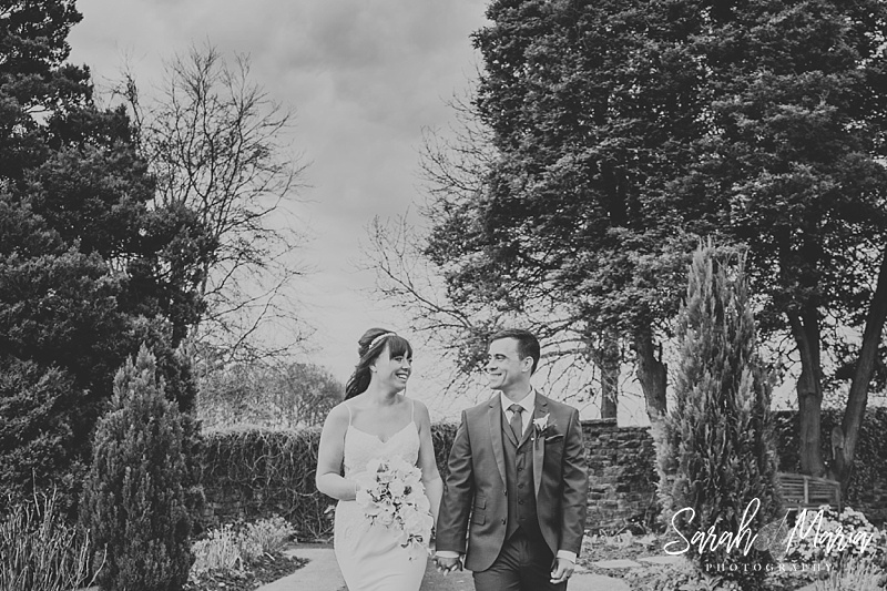 natural portrait of a bride and groom walking towards the camera