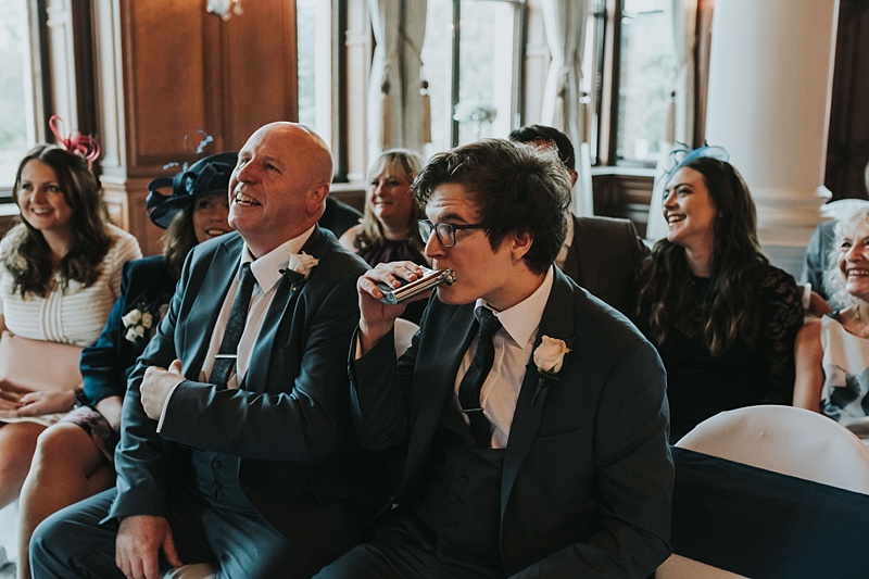 cheeky guest having a drink from a hip flash at a wedding